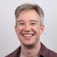 Photo of Tom Scott, smiling at the camera
